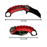 Navaja plegable tipo karambit con diseño de calavera y clip — imagen 2 de 4